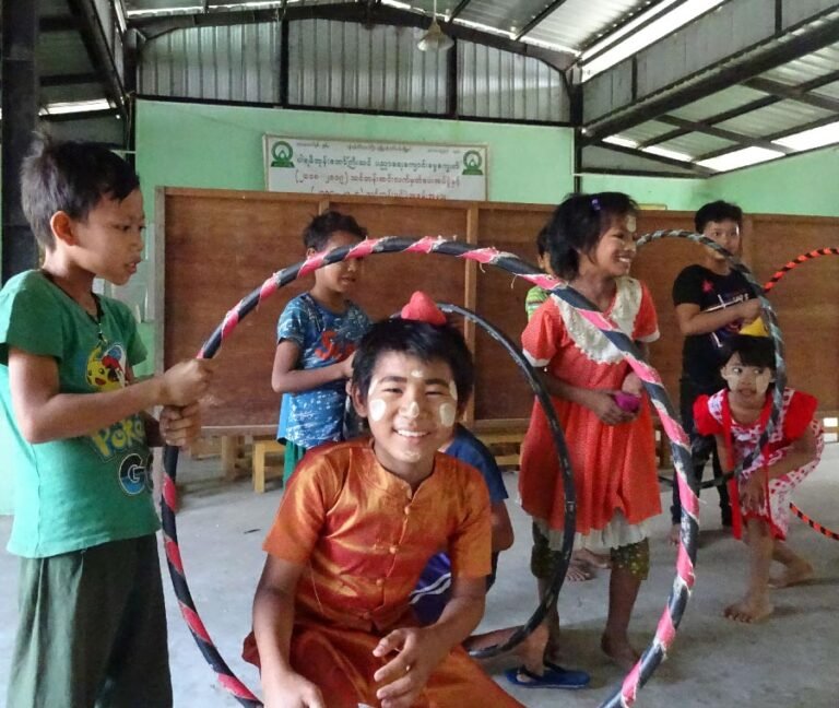 Myanmar child in a hoop ball balance game